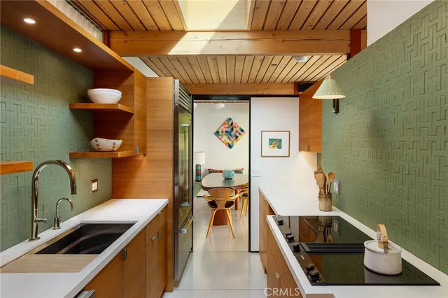 a kitchen with a sink a stove and a table