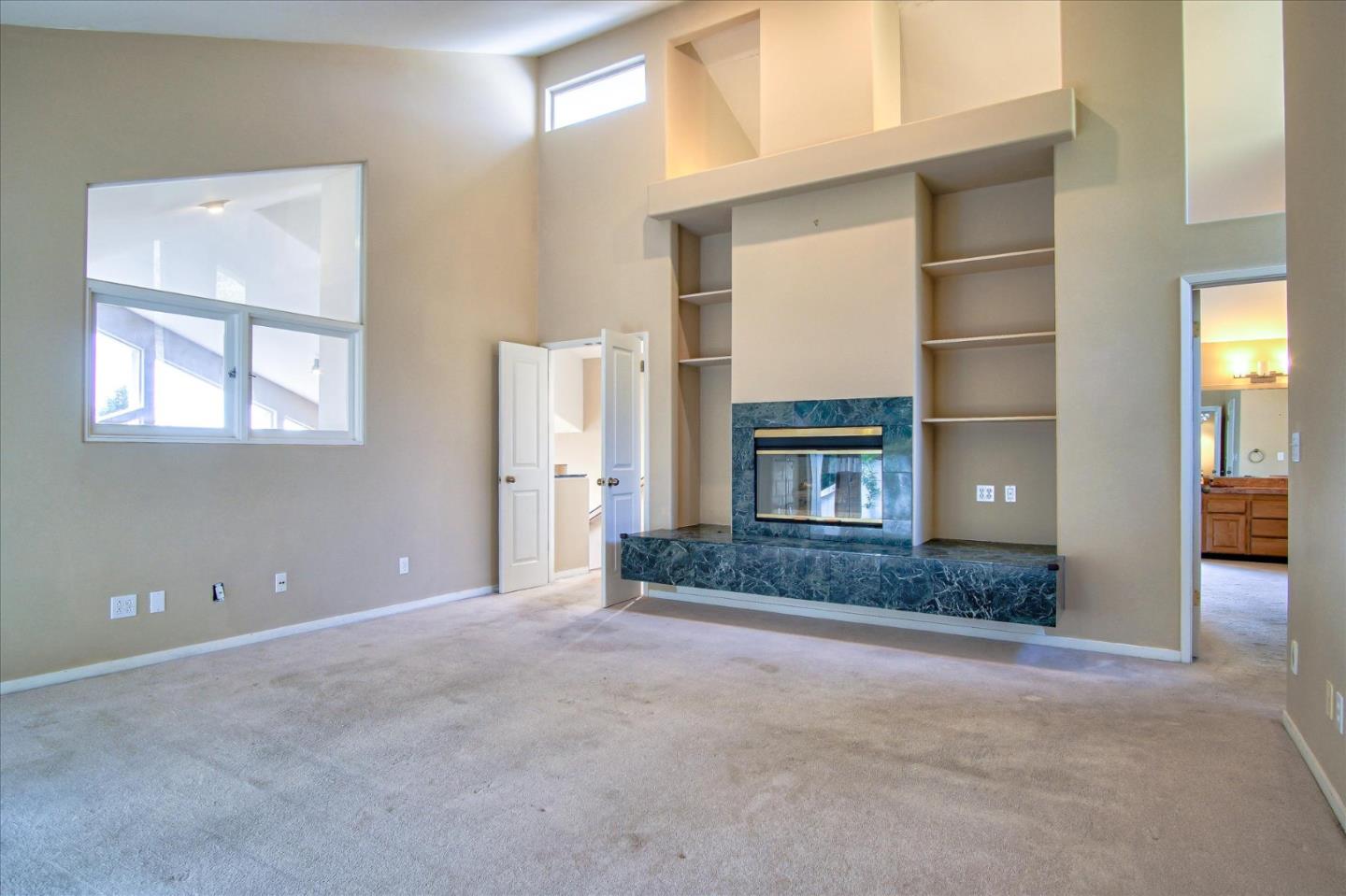 3435 Rio Road Carmel, CA 93923 - Photo 16 of 69 a living room with a fireplace and a window