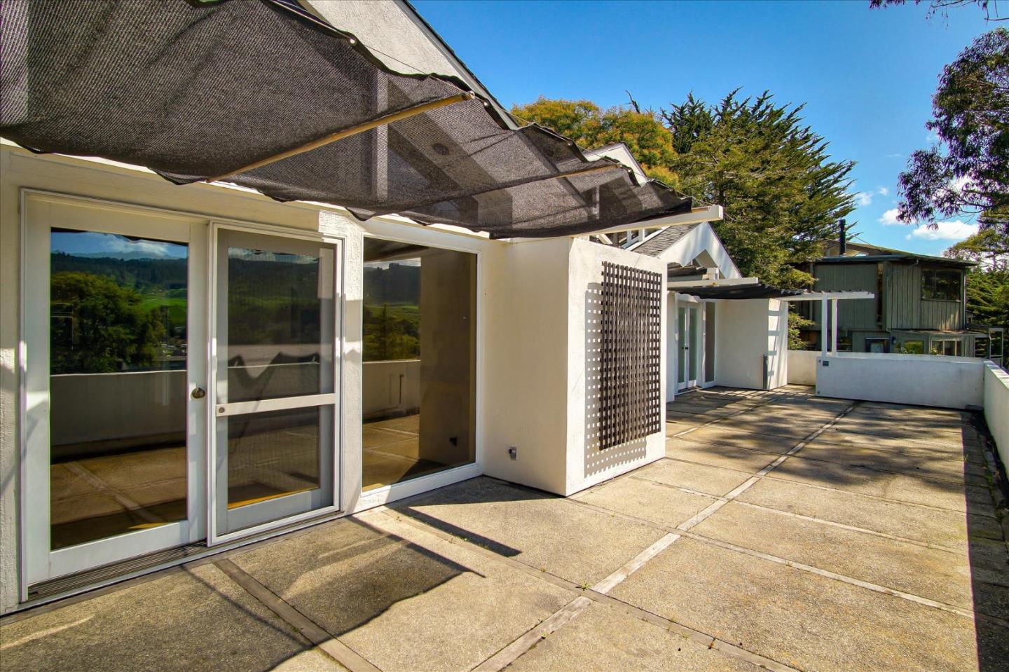 3435 Rio Road Carmel, CA 93923 - Photo 20 of 69 a view of a porch with a table and chairs under an umbrella