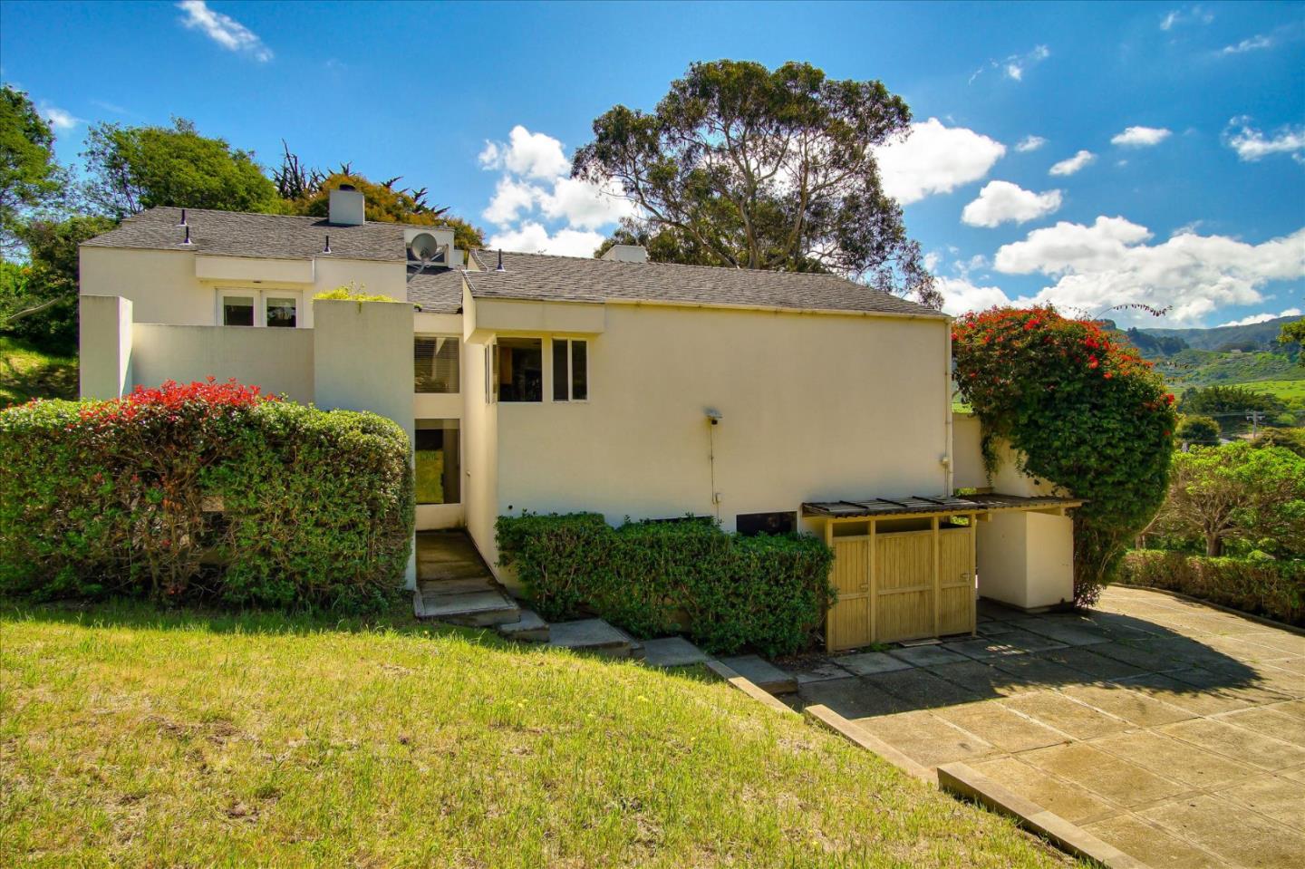 3435 Rio Road Carmel, CA 93923 - Photo 3 of 69 a front view of a house with a yard and garage