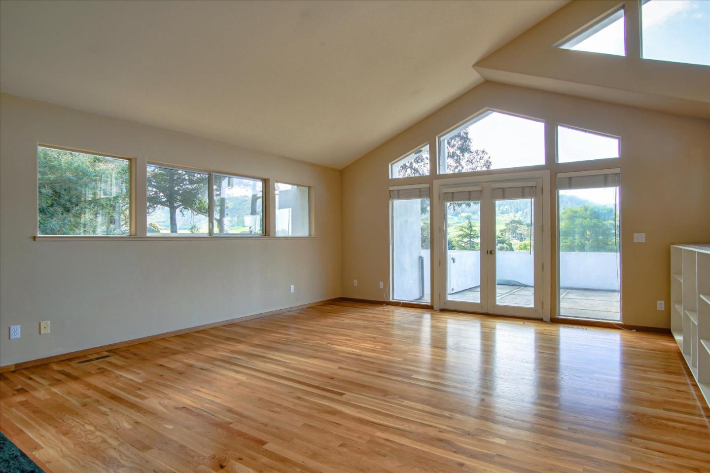 3435 Rio Road Carmel, CA 93923 - Photo 32 of 69 a view of an empty room with wooden floor and a window