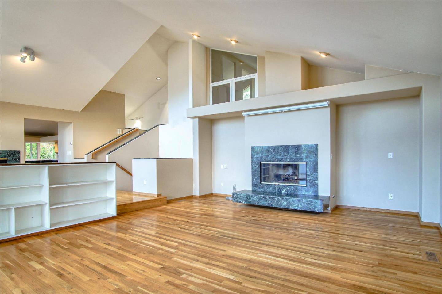 3435 Rio Road Carmel, CA 93923 - Photo 33 of 69 a view of an empty room with wooden floor and a kitchen