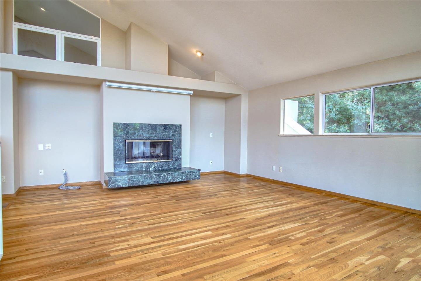 3435 Rio Road Carmel, CA 93923 - Photo 34 of 69 a view of empty room with fireplace and wooden floor