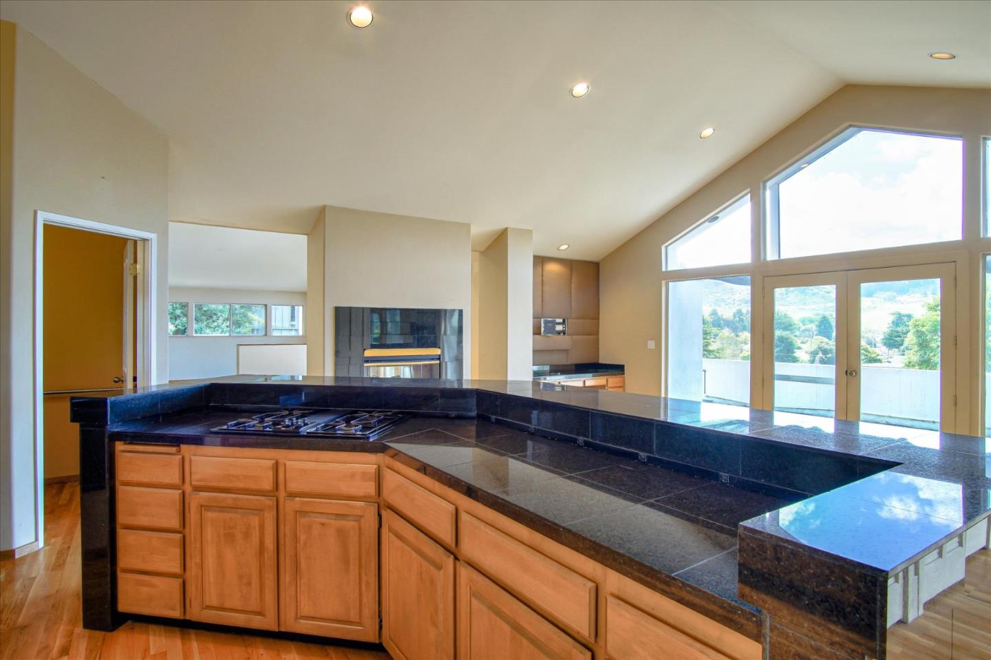3435 Rio Road Carmel, CA 93923 - Photo 37 of 69 a kitchen with stainless steel appliances granite countertop a stove a sink and a granite counter tops with wooden floors