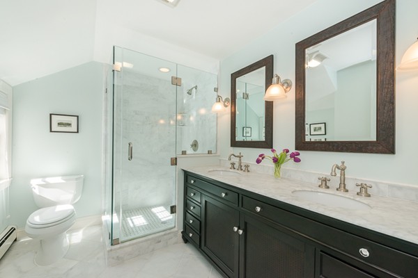 18 Woodside Road Topsfield, MA 01983 - Photo 20 of 30 a bathroom with a toilet a double vanity sink and a mirror