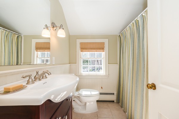 18 Woodside Road Topsfield, MA 01983 - Photo 25 of 30 a bathroom with a toilet sink and mirror