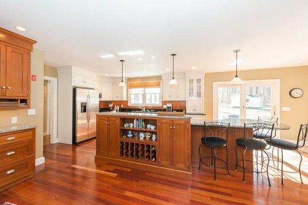 18 Woodside Road Topsfield, MA 01983 - Photo 3 of 30 a kitchen with stainless steel appliances granite countertop a table chairs refrigerator and sink