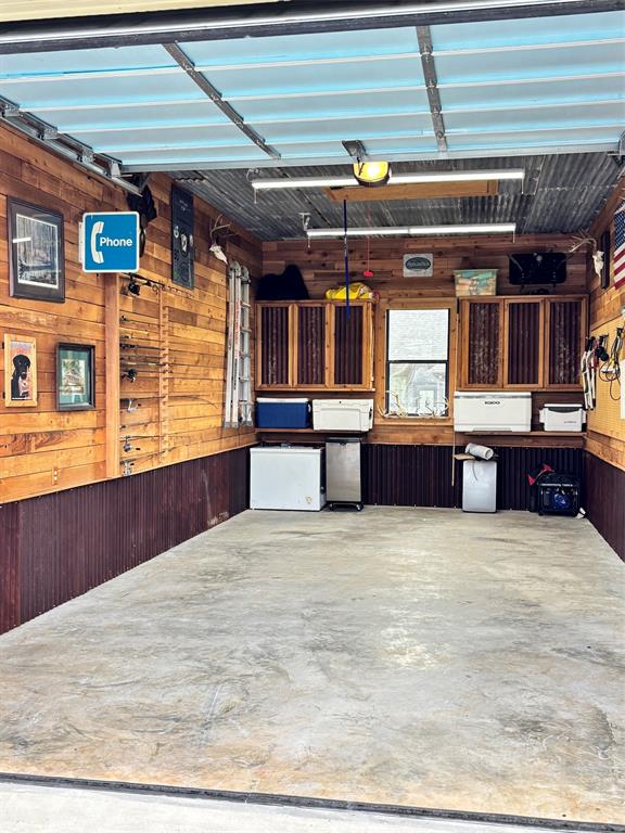 605 Jade Haughton, LA 71037 - Photo 33 of 34 Spacious garage featuring light wood-finish walls, corrugated metal wainscoting, and a concrete floor