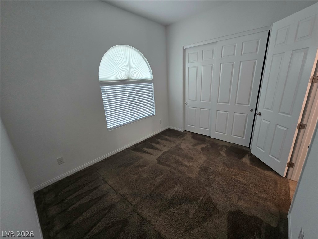 4748 Ritual Street North Las Vegas, NV 89031 - Photo 27 of 31 A well-lit bedroom with soft carpeting offers comfortable living space.