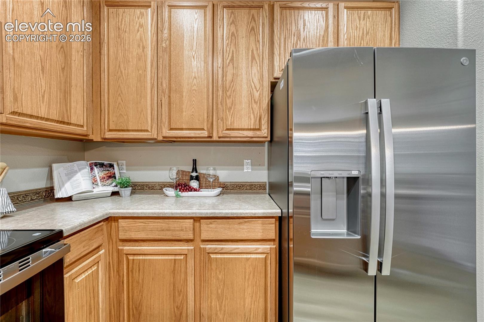 4147 Diamond Ridge View Colorado Springs, CO 80918 - Photo 14 of 42 A premium, brand-new stainless steel refrigerator integrates flawlessly with the wood-grain cabinetry, offering maximum food storage with modern style