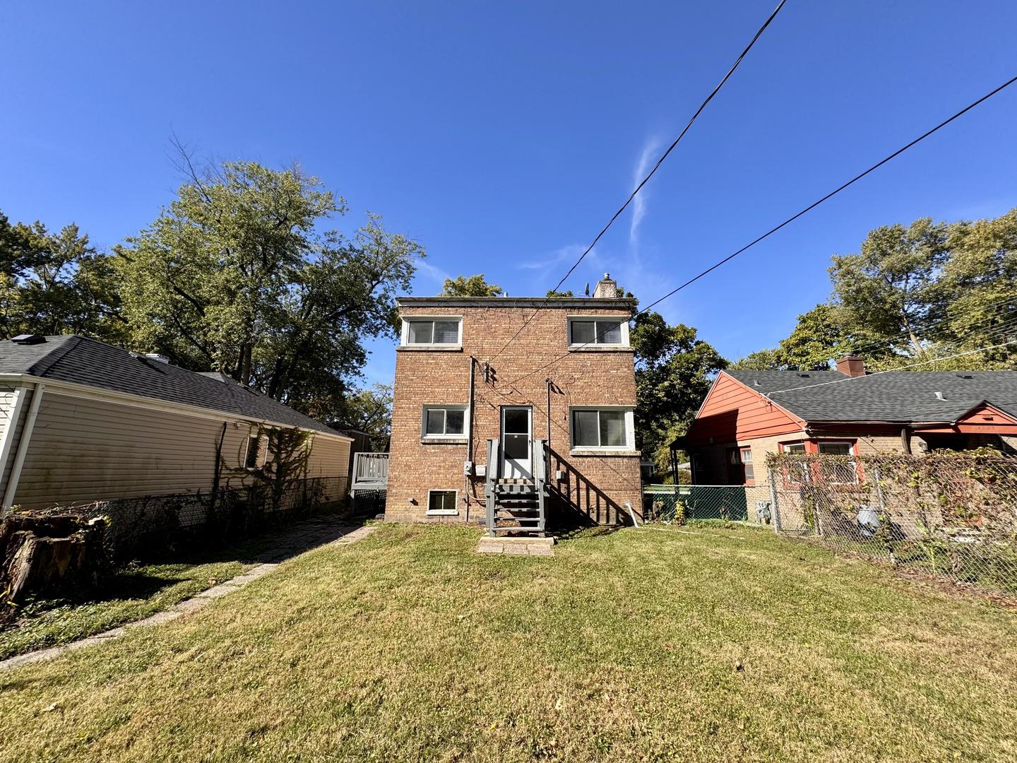 16727 Head Avenue Hazel Crest, IL 60429 - Photo 20 of 22 a view of a chair and tables in the backyard of a house