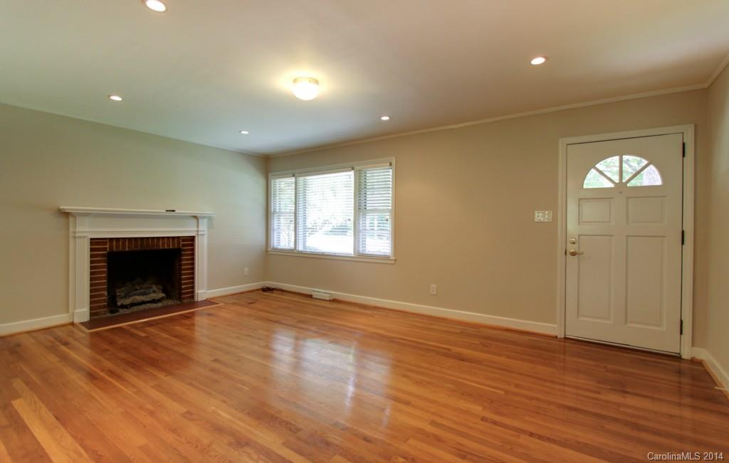538 Scaleybark Road Charlotte, NC 28209 - Photo 3 of 20 an empty room with wooden floor a fireplace and windows
