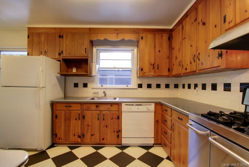 538 Scaleybark Road Charlotte, NC 28209 - Photo 7 of 20 a kitchen with stainless steel appliances a stove a sink and a refrigerator