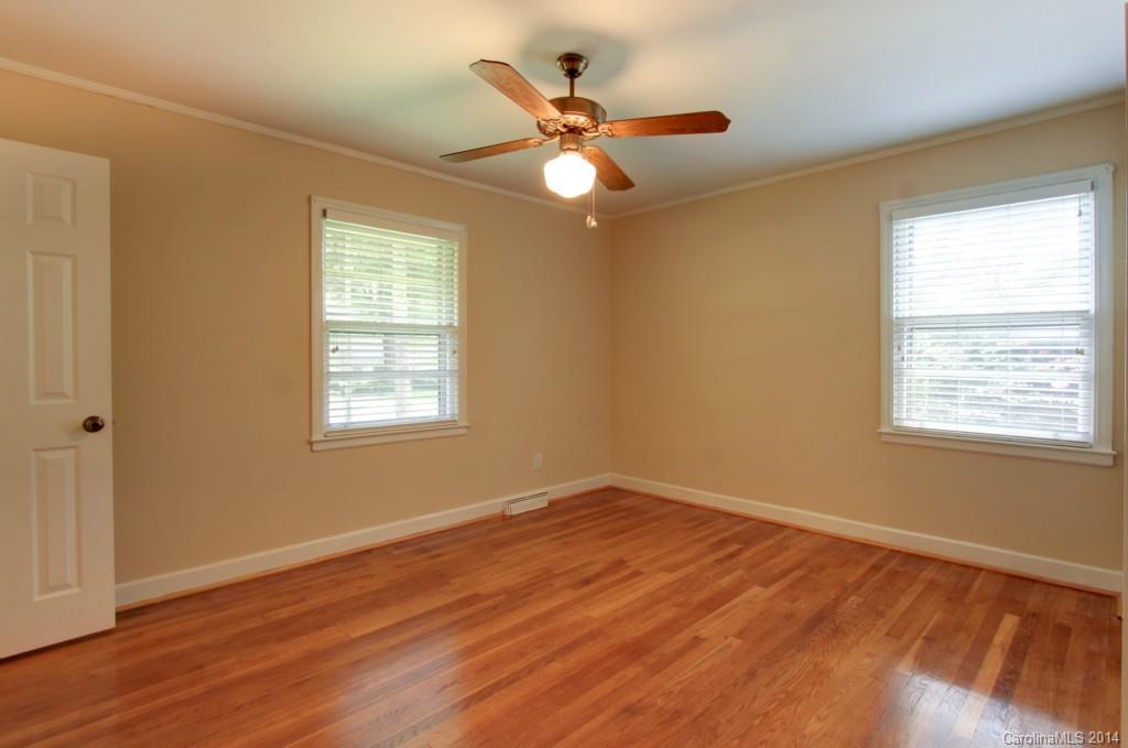 538 Scaleybark Road Charlotte, NC 28209 - Photo 10 of 20 a view of an empty room with wooden floor and a window