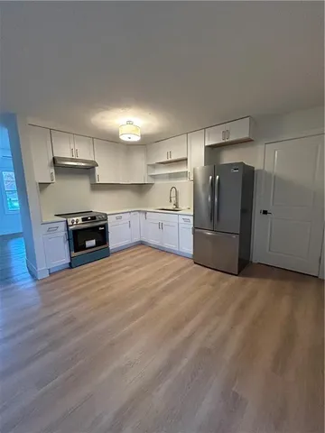 a kitchen with stainless steel appliances a refrigerator and a stove