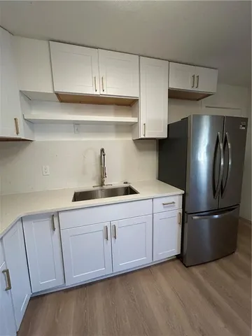 a kitchen with cabinets and stainless steel appliances