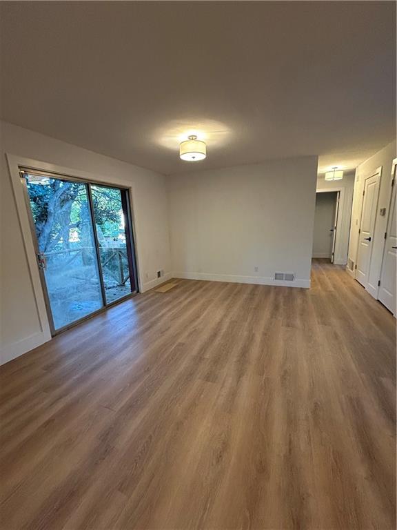 1270 Morrow Road Morrow, GA 30260 - Photo 5 of 12 an empty room with wooden floor and windows