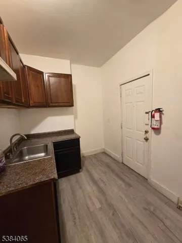 a kitchen with wooden cabinets and a sink