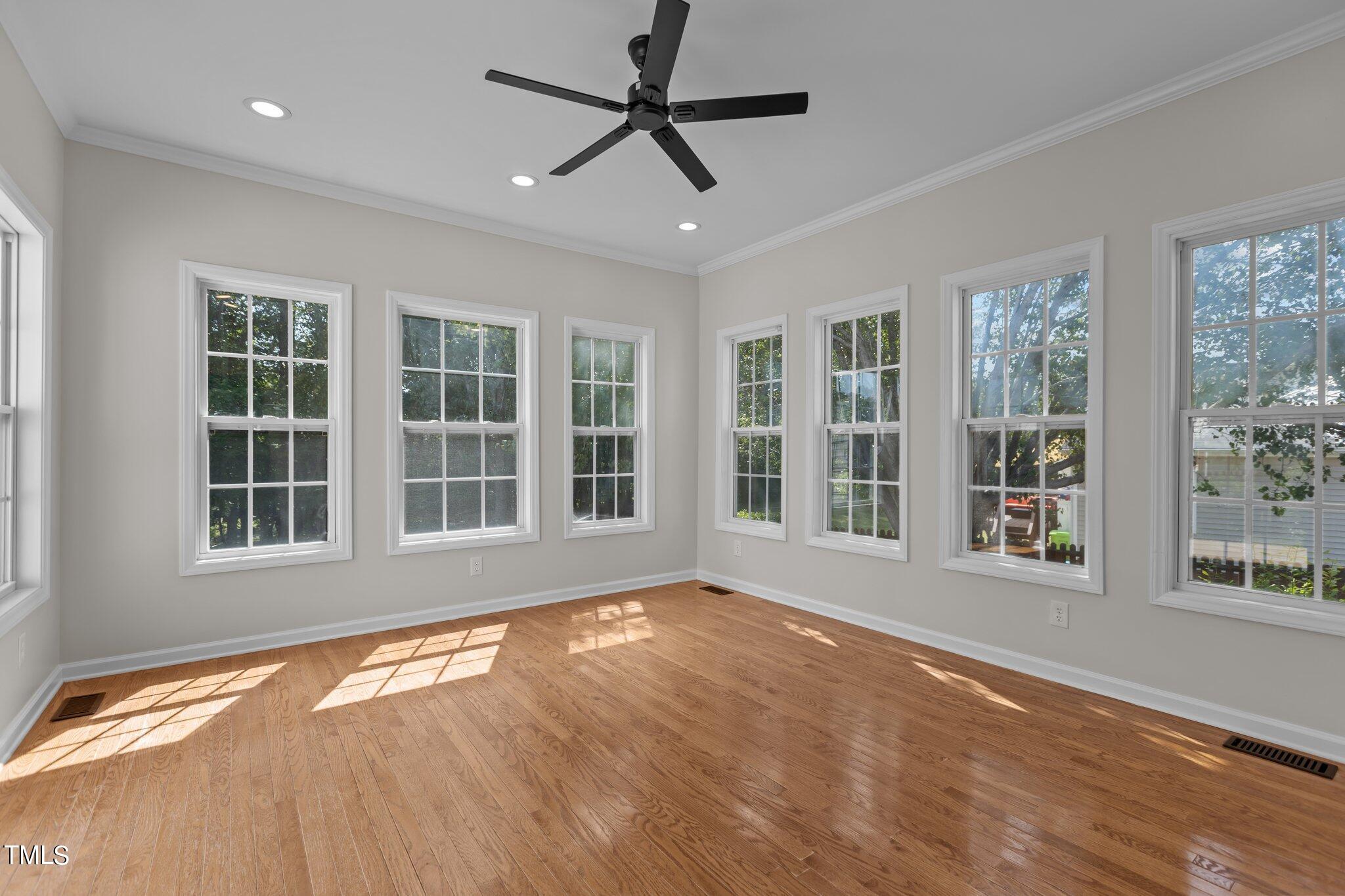 3225 Forest Mill Circle Raleigh, NC 27616 - Photo 12 of 36 a view of an empty room with a window and wooden floor