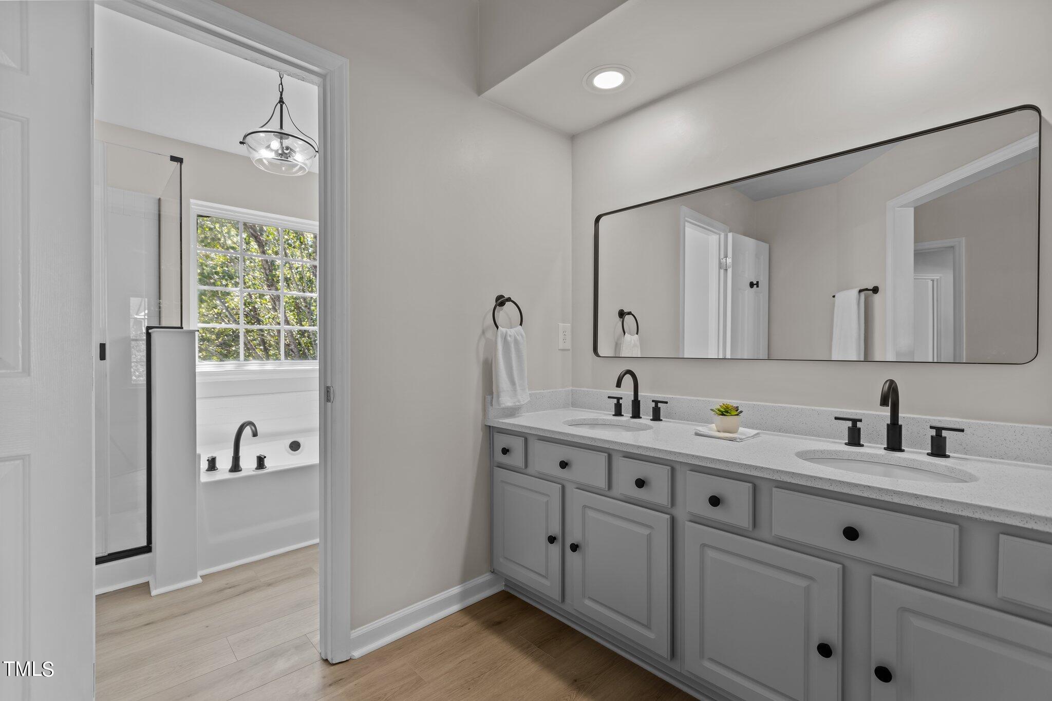 3225 Forest Mill Circle Raleigh, NC 27616 - Photo 20 of 36 a bathroom with a double vanity sink and mirror