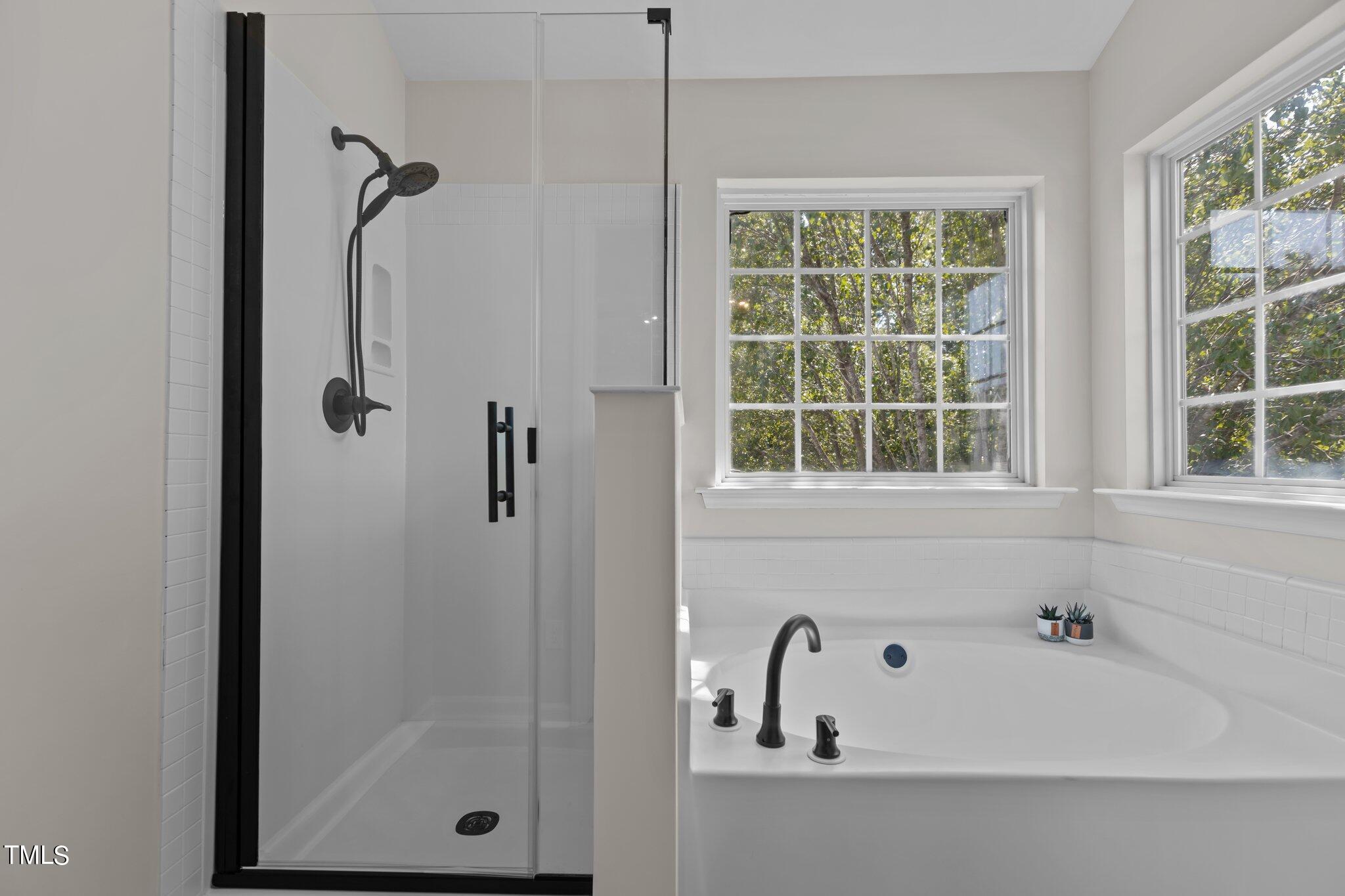 3225 Forest Mill Circle Raleigh, NC 27616 - Photo 21 of 36 a bathroom with a bathtub and a window