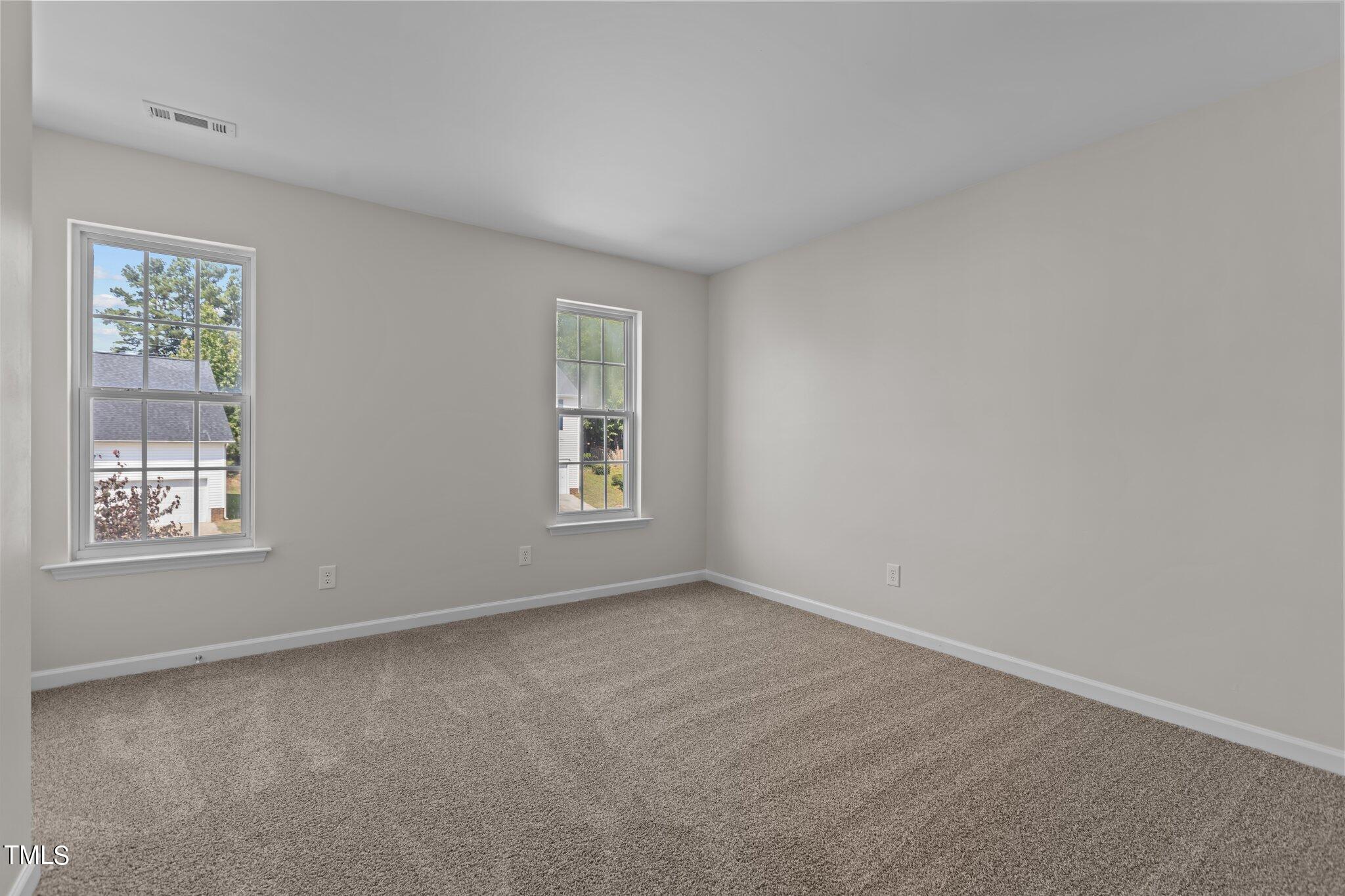 3225 Forest Mill Circle Raleigh, NC 27616 - Photo 23 of 36 an empty room with windows