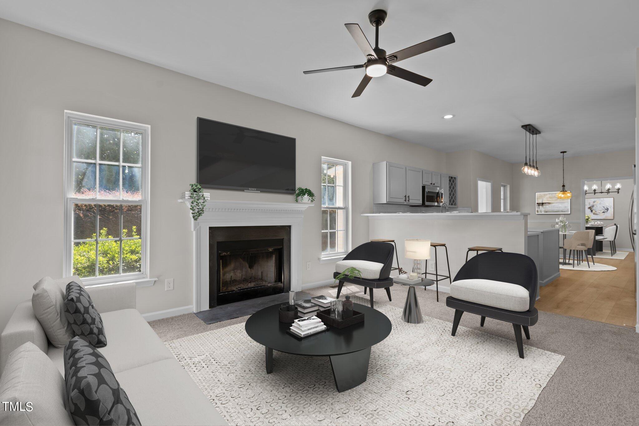 3225 Forest Mill Circle Raleigh, NC 27616 - Photo 3 of 36 a living room with furniture a window and a fireplace