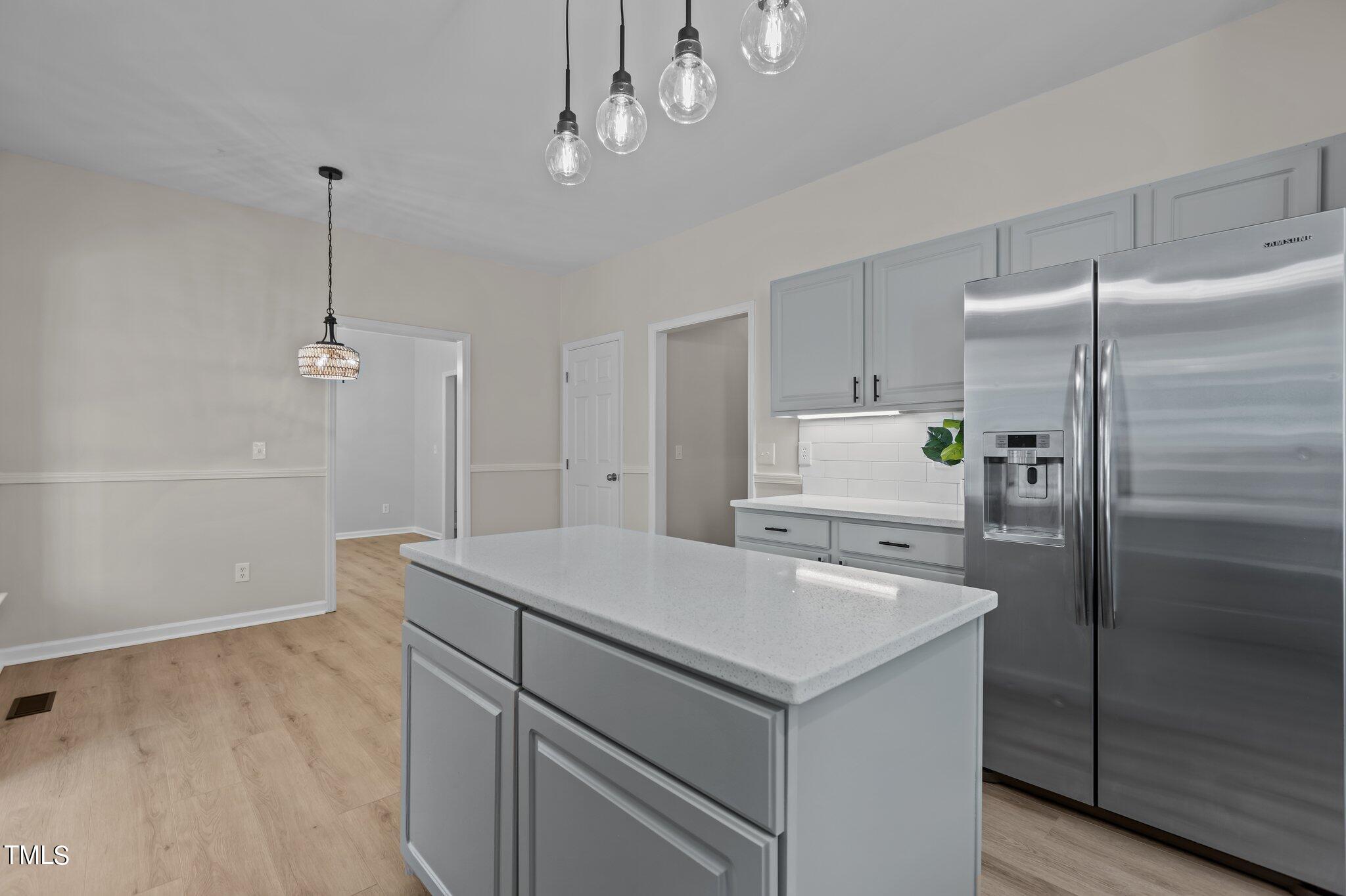 3225 Forest Mill Circle Raleigh, NC 27616 - Photo 7 of 36 a kitchen that has a refrigerator a sink and cabinets