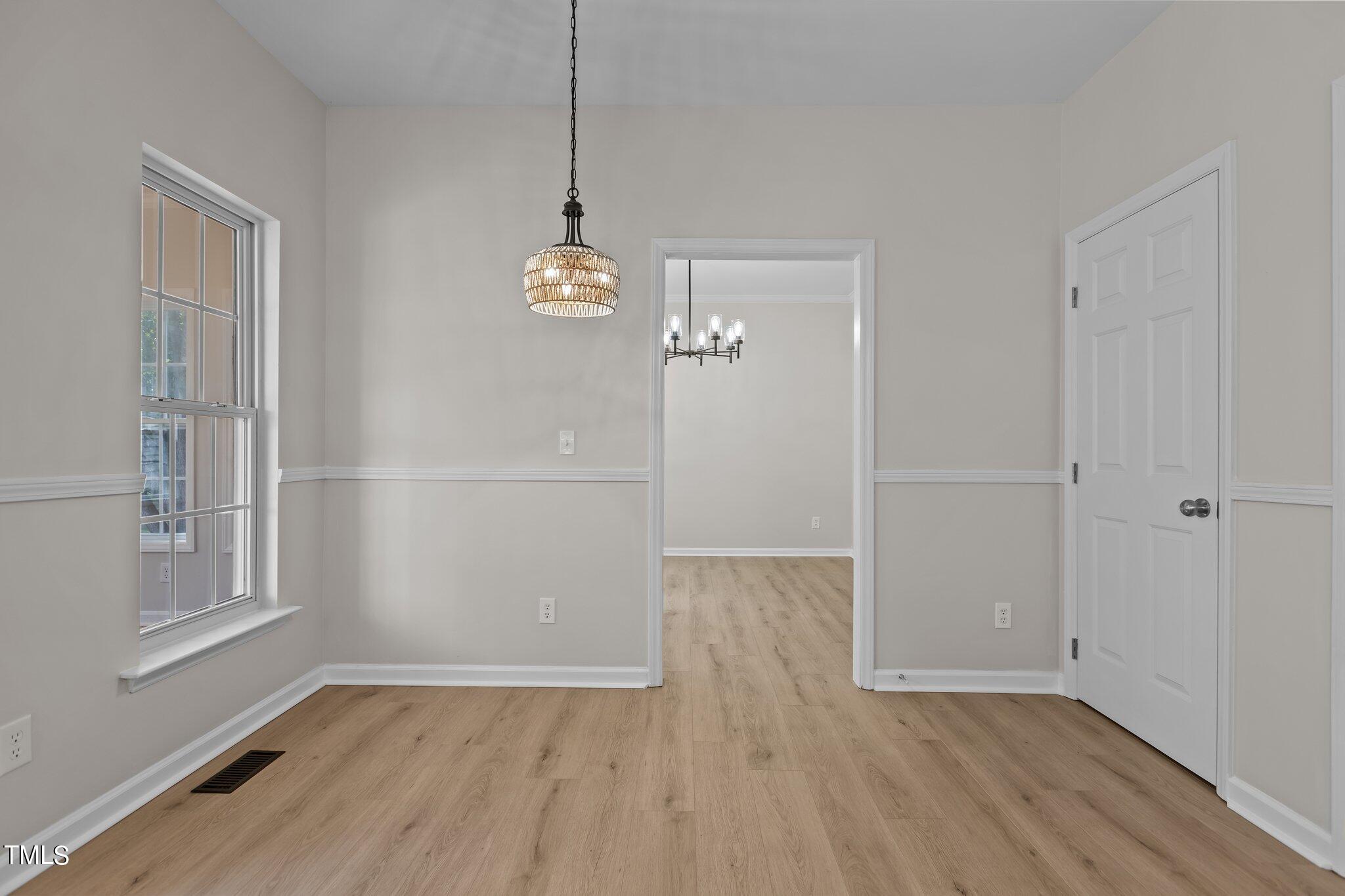 3225 Forest Mill Circle Raleigh, NC 27616 - Photo 10 of 36 a view of empty room with wooden floor