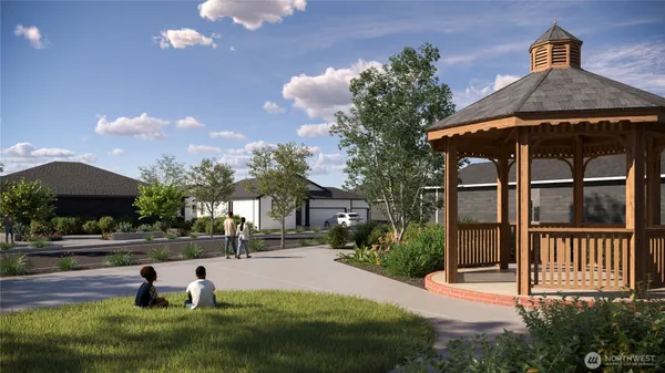 a view of a house with backyard and sitting area