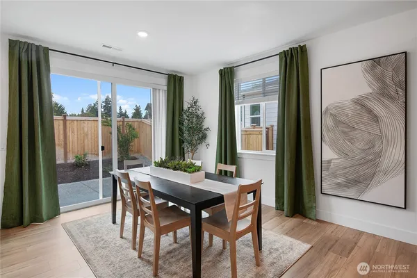 a view of a dining room with furniture window and wooden floor