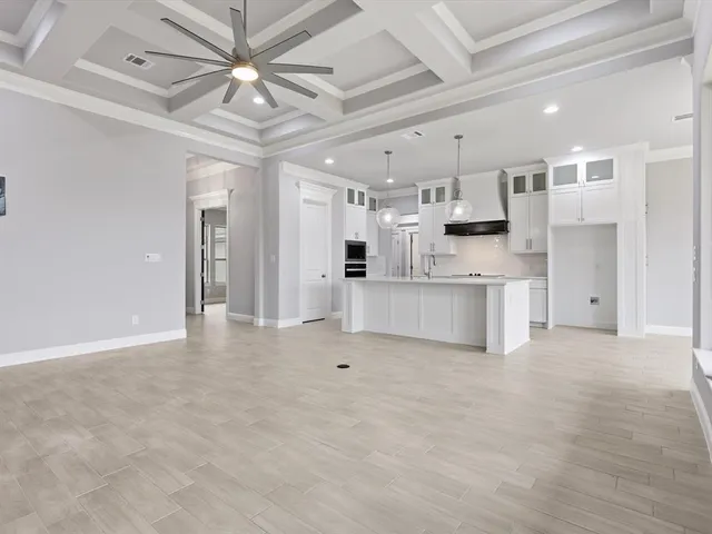 a view of a kitchen with refrigerator and a sink