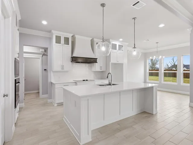 a large kitchen with kitchen island a sink stainless steel appliances and cabinets