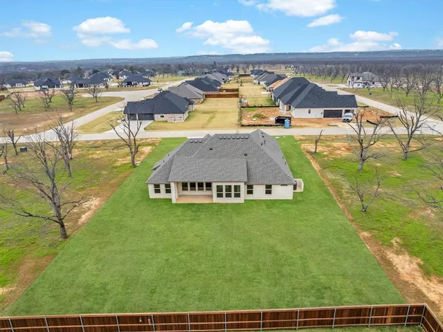 an aerial view of residential houses with outdoor space