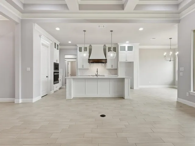 a view of kitchen with kitchen island cabinets and refrigerator