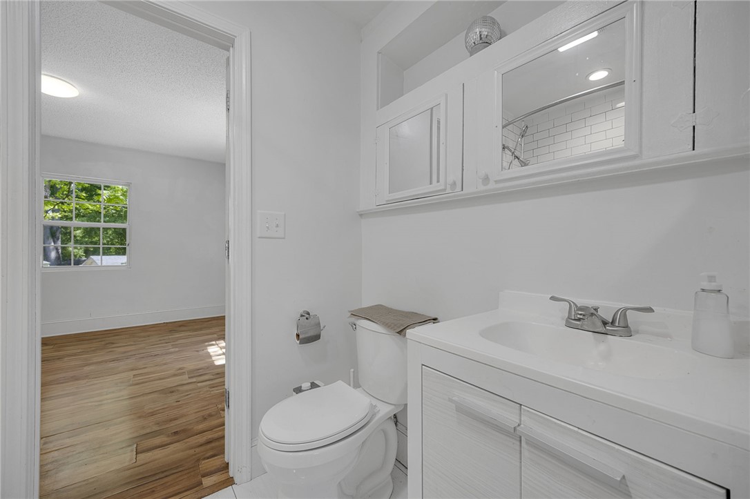 1616 Meadow Brook Circle Anderson, SC 29624 - Photo 16 of 24 This bright bathroom features a vanity, toilet, and convenient built-in storage with a view to an adjacent room.