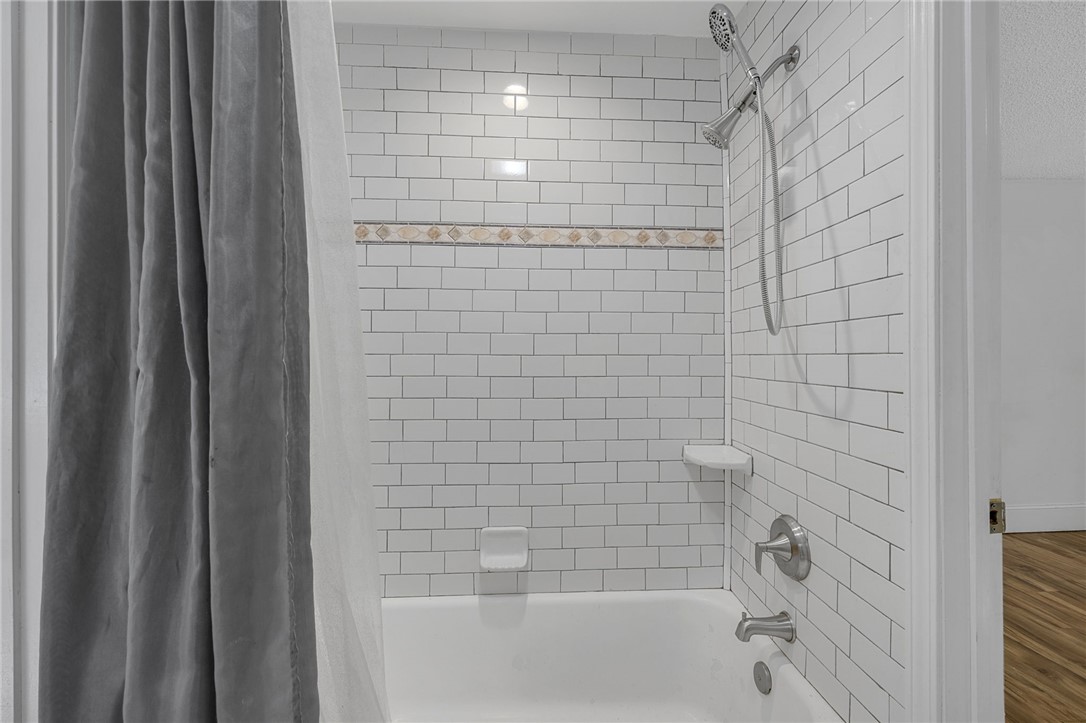1616 Meadow Brook Circle Anderson, SC 29624 - Photo 17 of 24 This sleek bathroom features a bathtub with subway tile, offering a crisp, clean aesthetic.