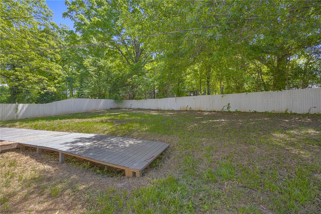 1616 Meadow Brook Circle Anderson, SC 29624 - Photo 21 of 24 This spacious yard offers a serene backdrop for outdoor enjoyment with mature trees and a privacy fence.