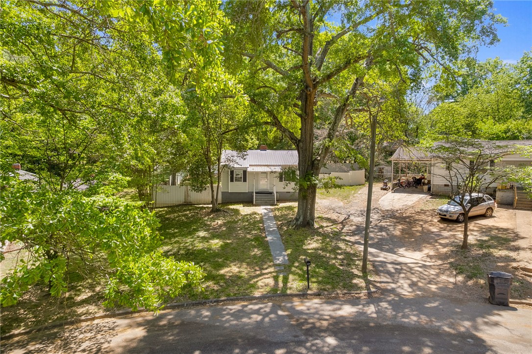 1616 Meadow Brook Circle Anderson, SC 29624 - Photo 22 of 24 This charming home features a well-maintained lawn and mature trees, offering a serene outdoor setting.