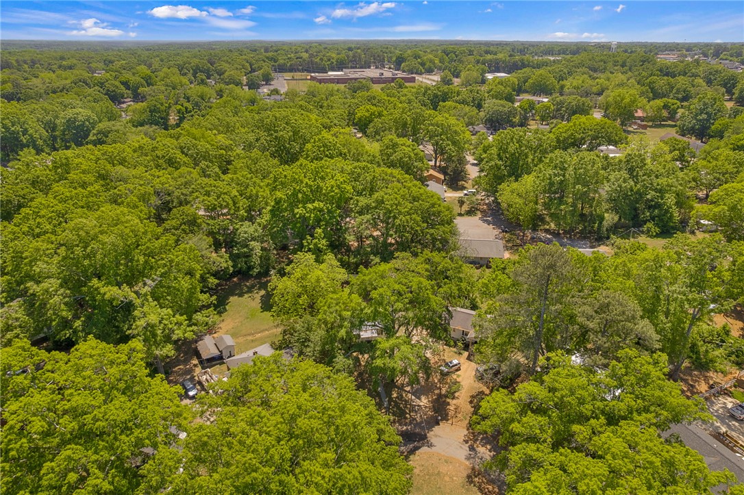 1616 Meadow Brook Circle Anderson, SC 29624 - Photo 23 of 24 An aerial perspective reveals a verdant landscape with homes nestled amongst lush trees under a clear sky.