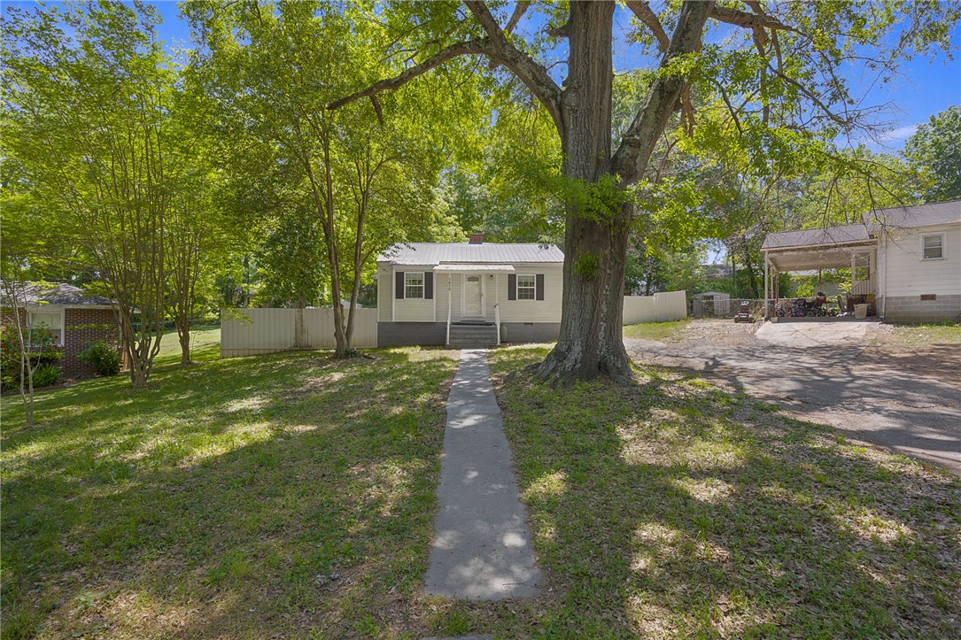 1616 Meadow Brook Circle Anderson, SC 29624 - Photo 3 of 24 This inviting home is nestled on a lush lot with mature trees and a classic, welcoming facade.