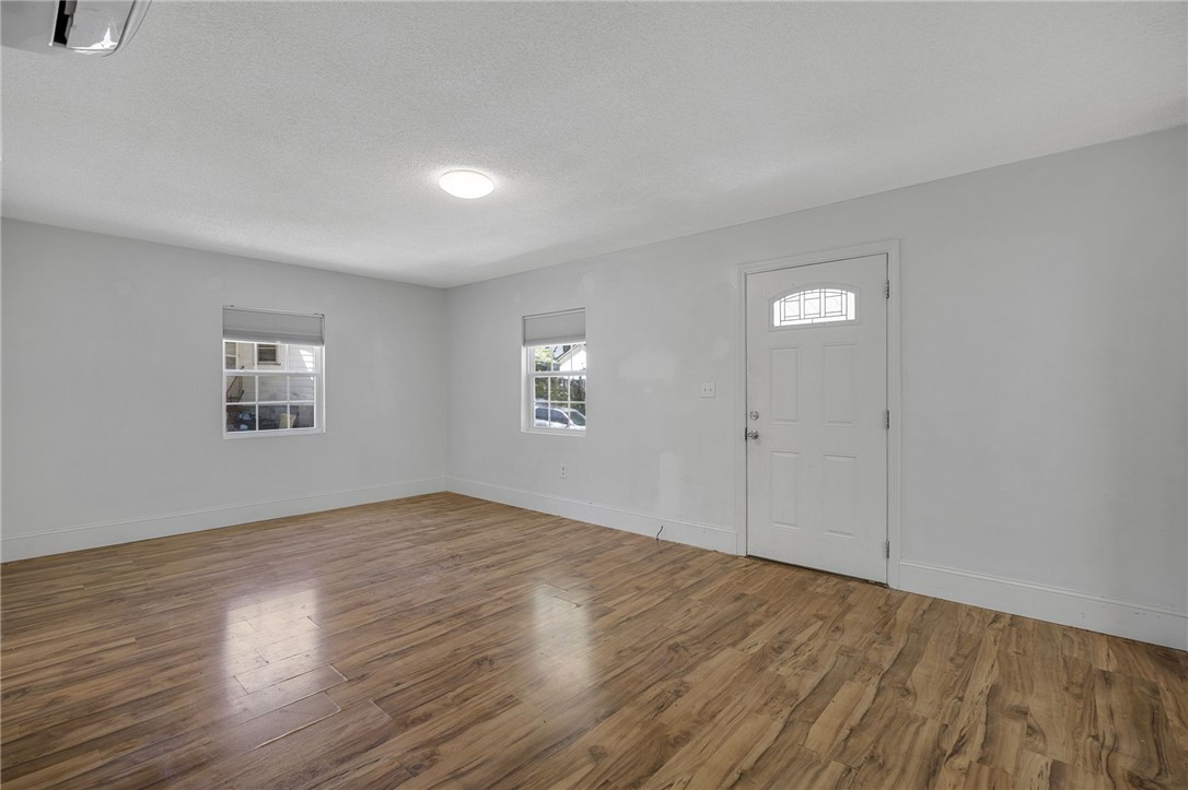 1616 Meadow Brook Circle Anderson, SC 29624 - Photo 5 of 24 This bright living space features durable wood flooring and a classic front door with a window.