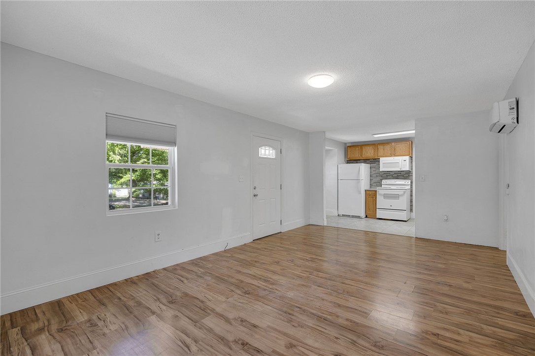 1616 Meadow Brook Circle Anderson, SC 29624 - Photo 7 of 24 This living space features durable wood flooring and ample natural light, with a functional kitchen nearby.