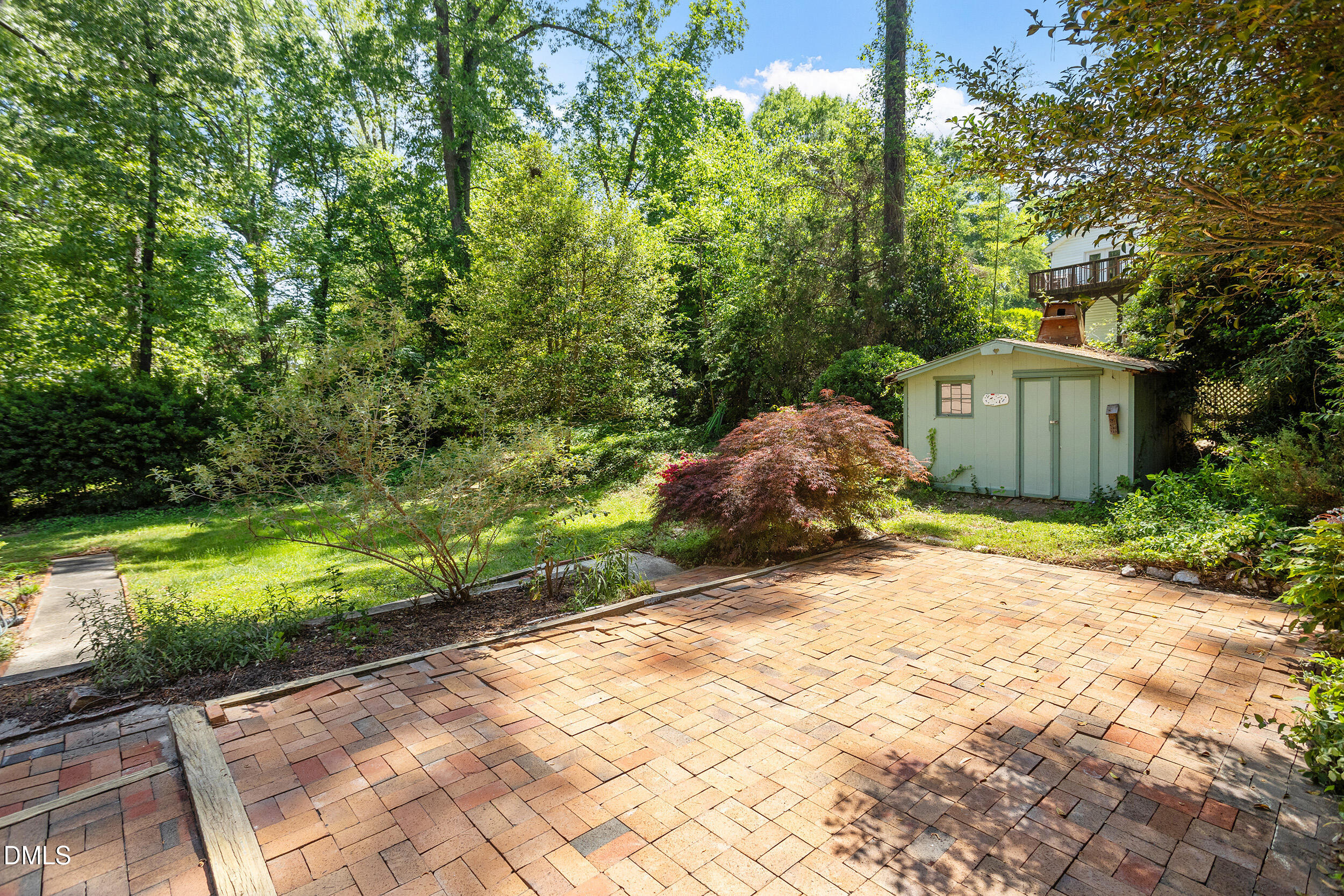4711 Tanglewood Drive Raleigh, NC 27612 - Photo 26 of 39 a front view of a house with a yard and shrubs