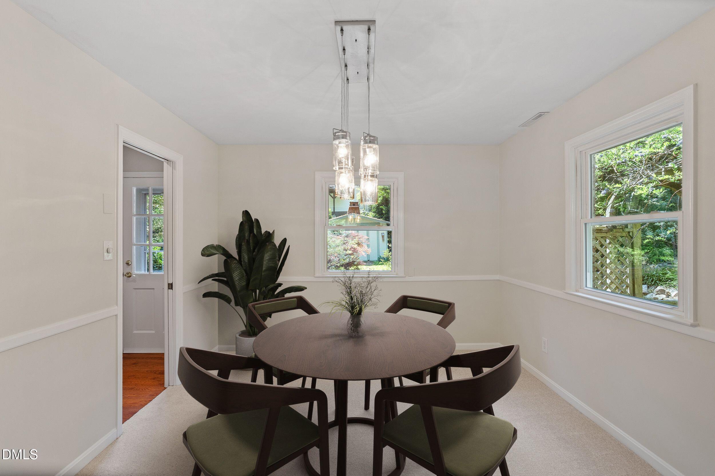 4711 Tanglewood Drive Raleigh, NC 27612 - Photo 4 of 39 a view of a dining room with furniture window and outside view
