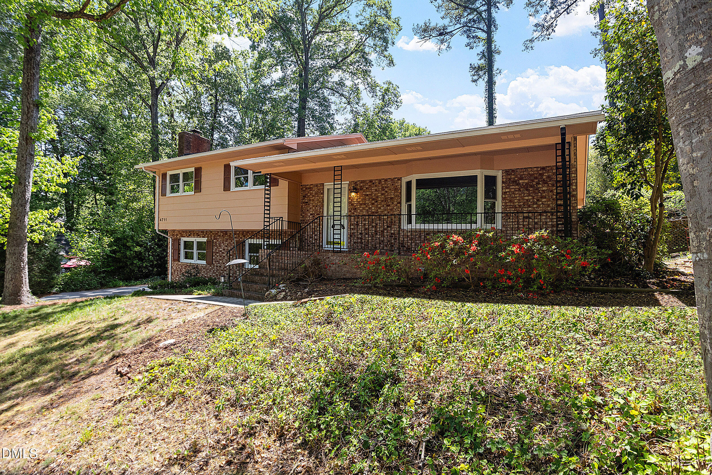 4711 Tanglewood Drive Raleigh, NC 27612 - Photo 8 of 39 a front view of a house with a yard