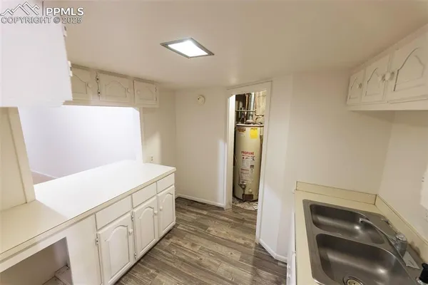 a view of walk in closet with wooden floor