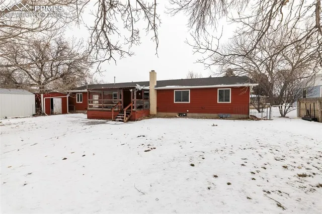 a view of a house with snow on the road