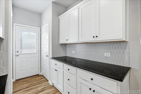 a kitchen with white cabinets and a sink