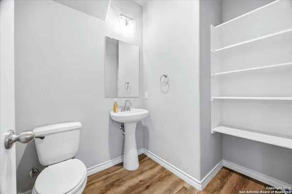 a bathroom with a toilet sink and mirror